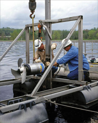 At the Stevenson, Ala., mill, a rebuilt mixer is installed on one of 16 rafts, while the raft is held ashore by cables. Once installed, the raft will be repositioned in the aerated stabilization basin