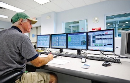 man looking at a computer maintenance management system