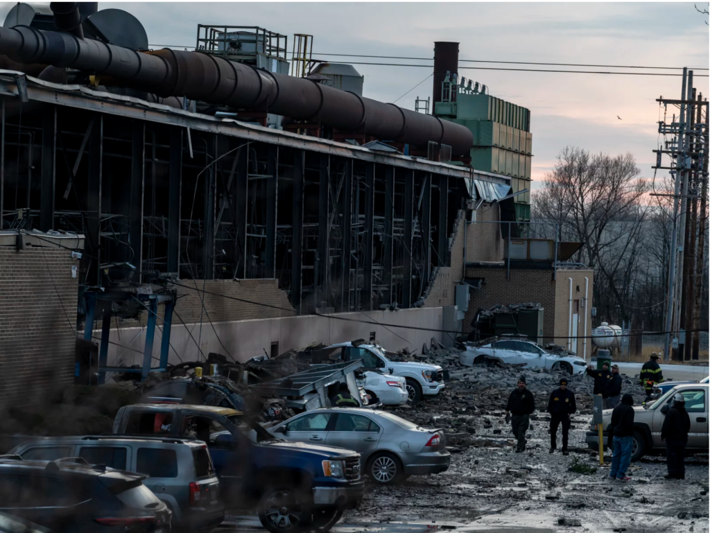 Image of the ohio foundry explosion where the entire wall of the plant has been blown off by the explosion, cars in the parking lot are covered with debris