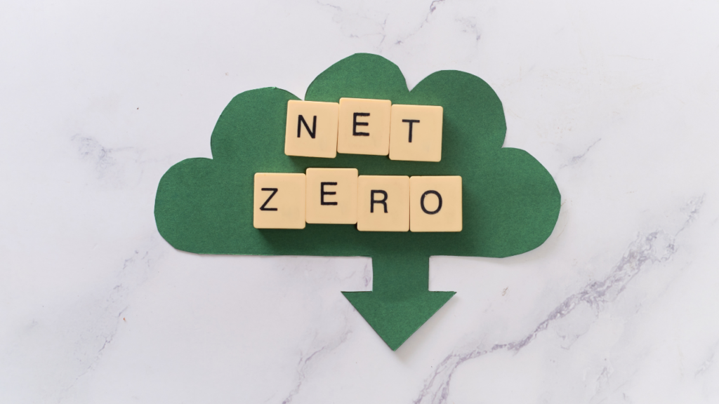 image of a green cloud with an arrow pointing down and the words "net zero" written in wooden blocks