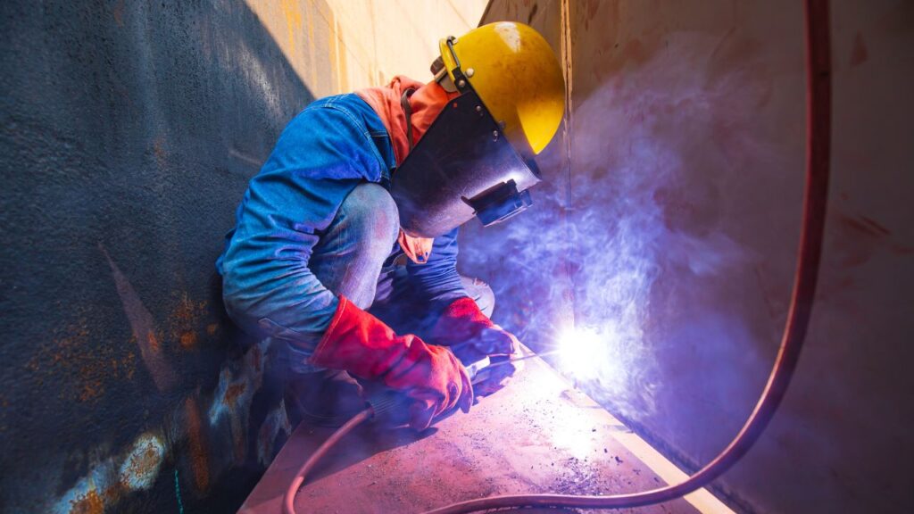 welder working in confined space - confined space entry safety