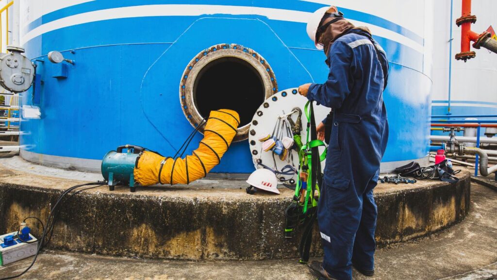 maintenance worker getting ready for work outside a confined space - confined space entry safety