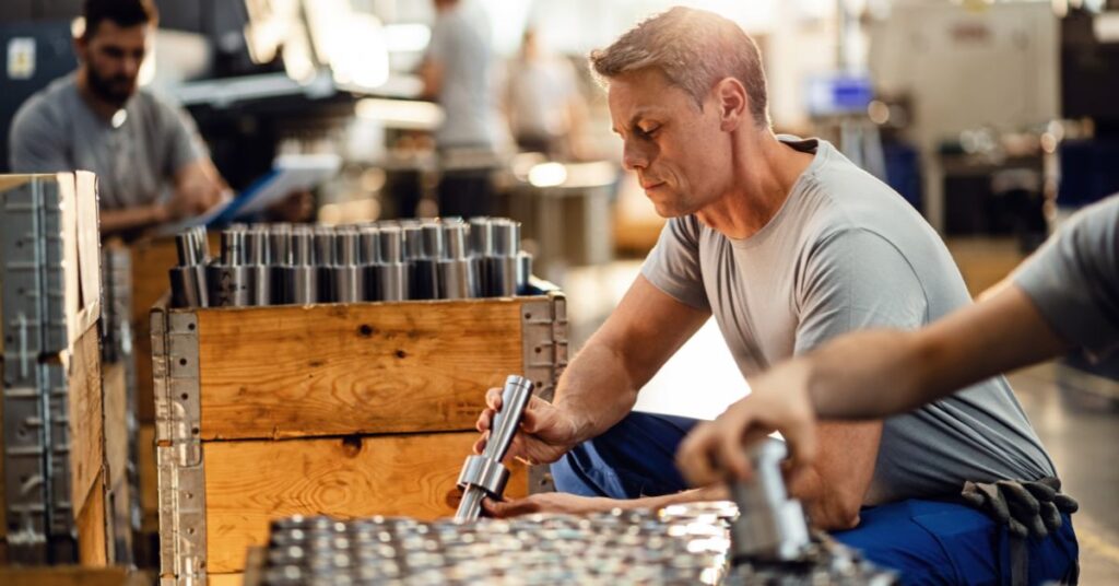 factory workers with car parts

